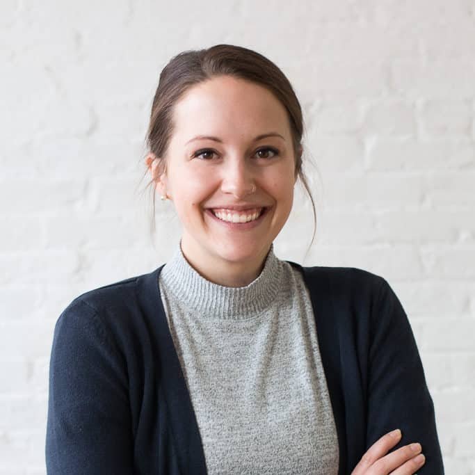 Person with crossed arms, neutral expression.