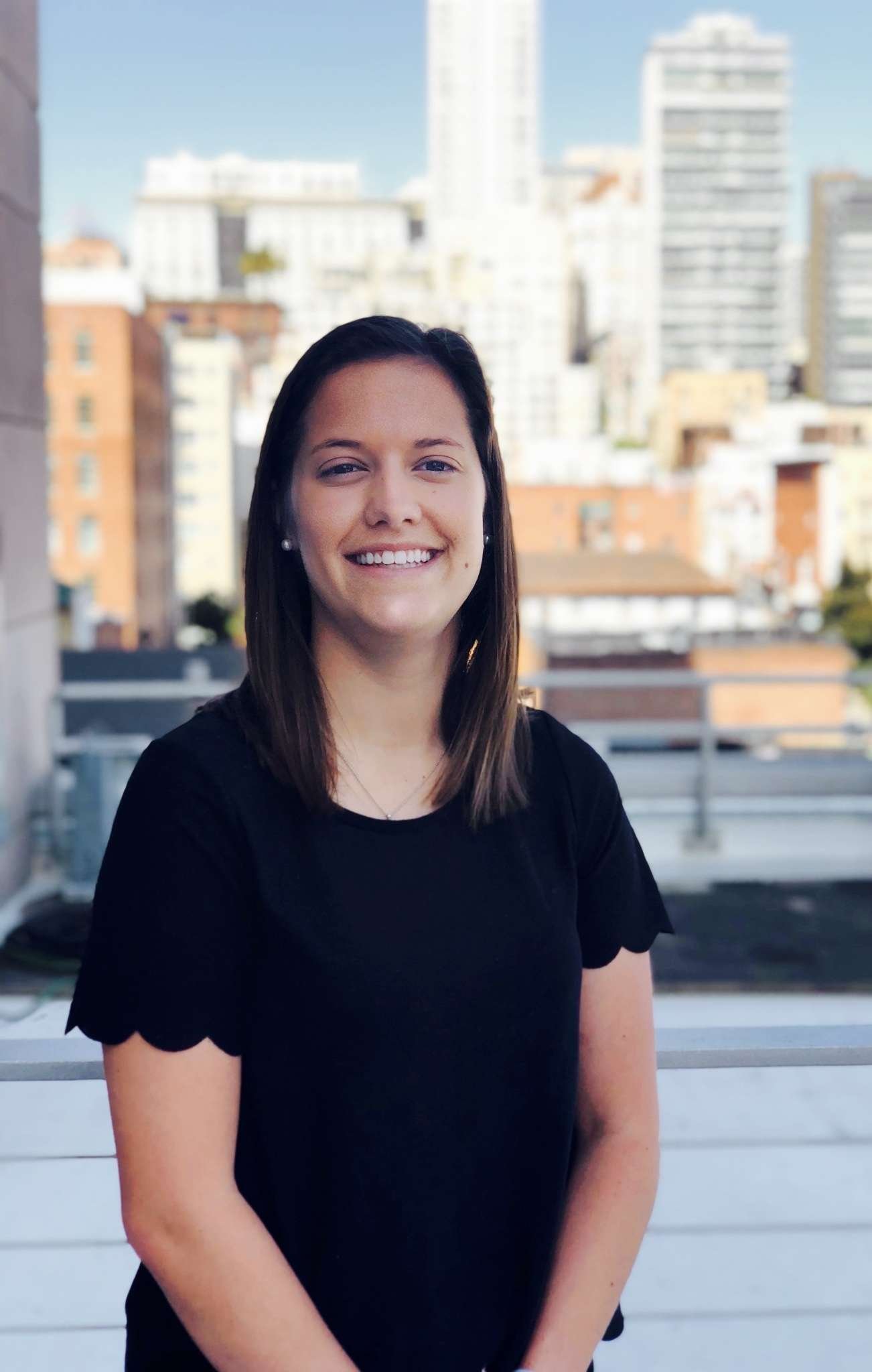 Person standing with city skyline background.